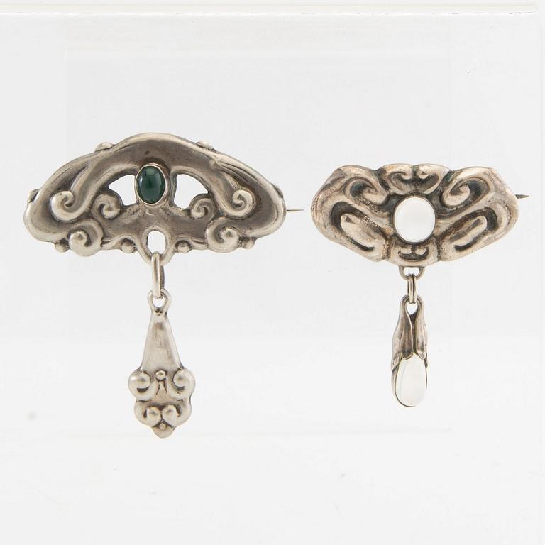 Brooches, 2 pieces, Art Nouveau, early 20th century, pewter, moonstone, and green stone.
