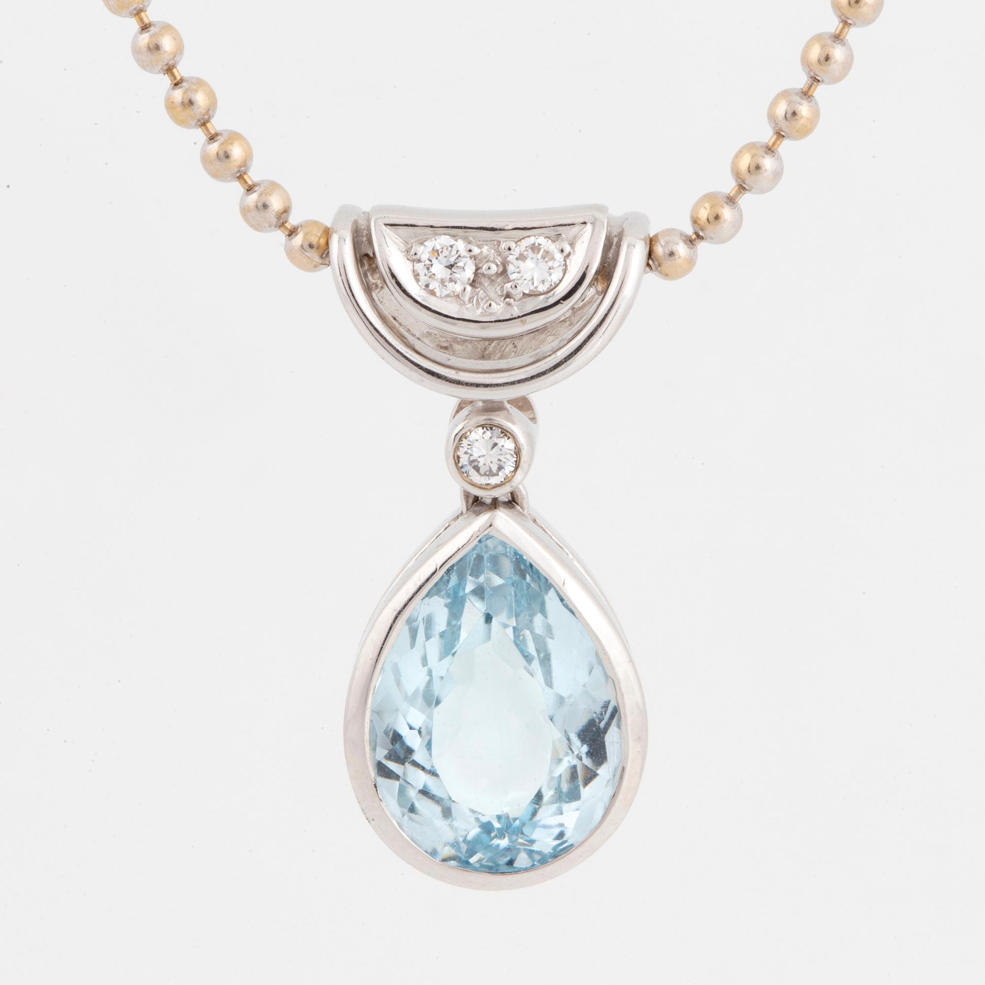 White gold chain and pendant with pearshaped topaz and brilliant-cut diamonds.
