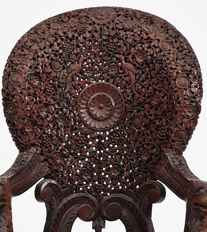 A pair of carved 'blackwood' armchairs, Bombay presidency, British Raj, circa 1880.