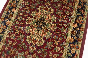 A silk Qum rug, Central Iran, signed, c. 170 x 101 cm.