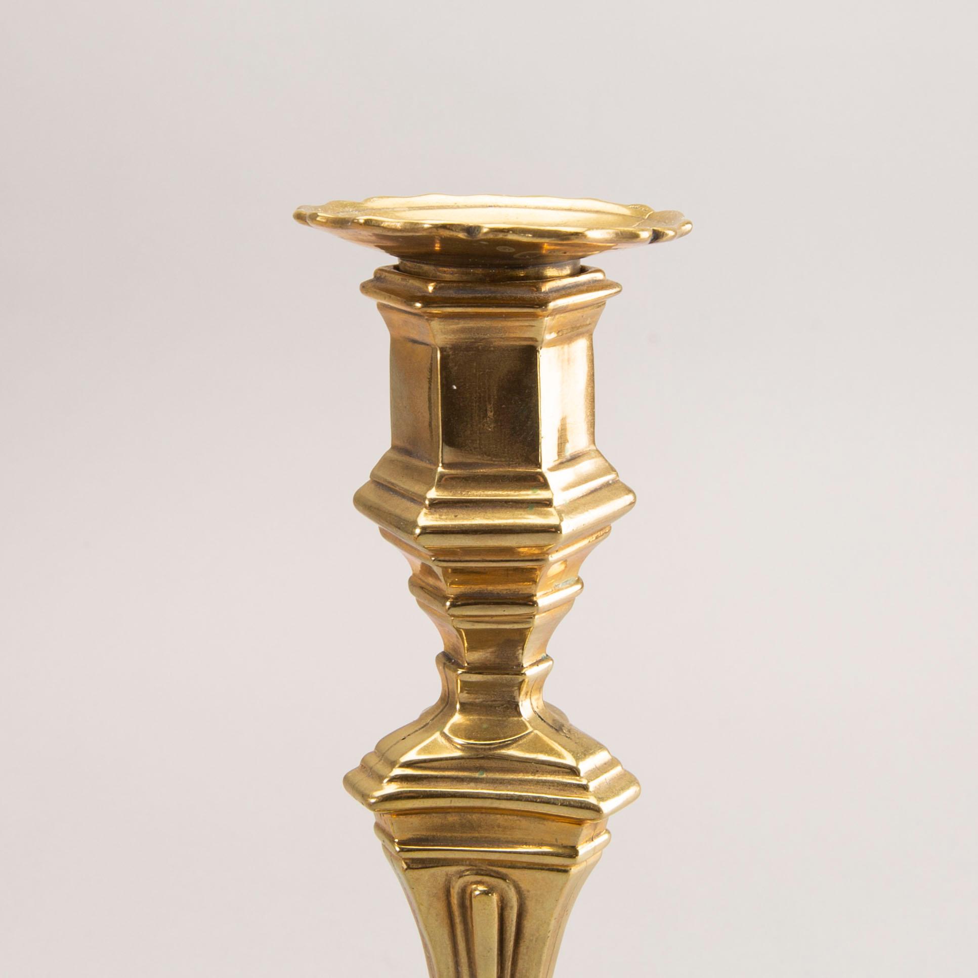 A pair of rococo brass candlesticks, possibly France.