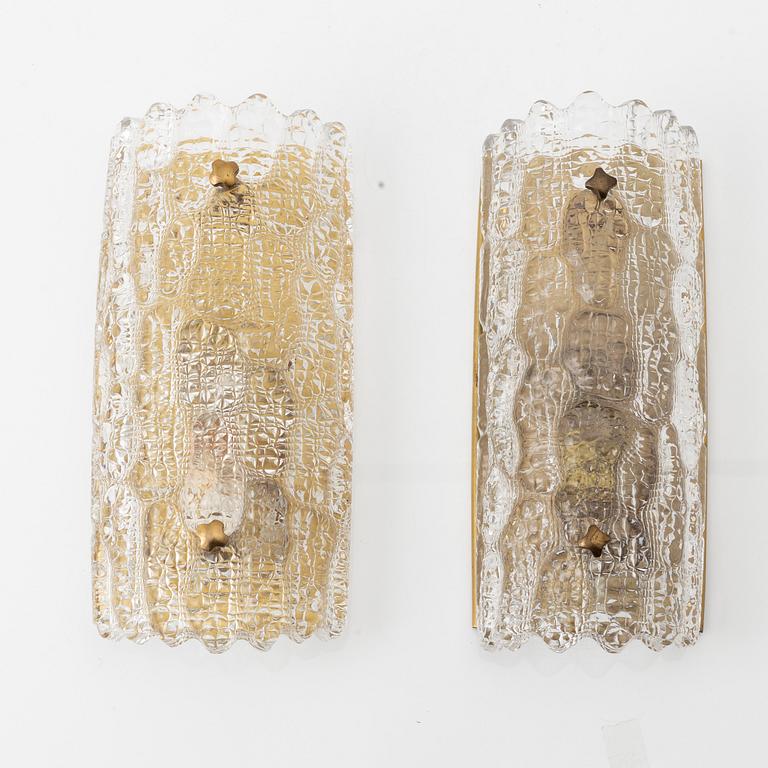 Carl Fagerlund, two brass and glass wall lights, Orrefors, later part of the 20th Century.