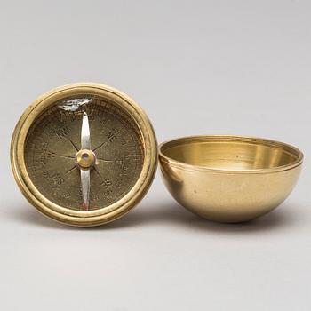 A walking stick with compass.