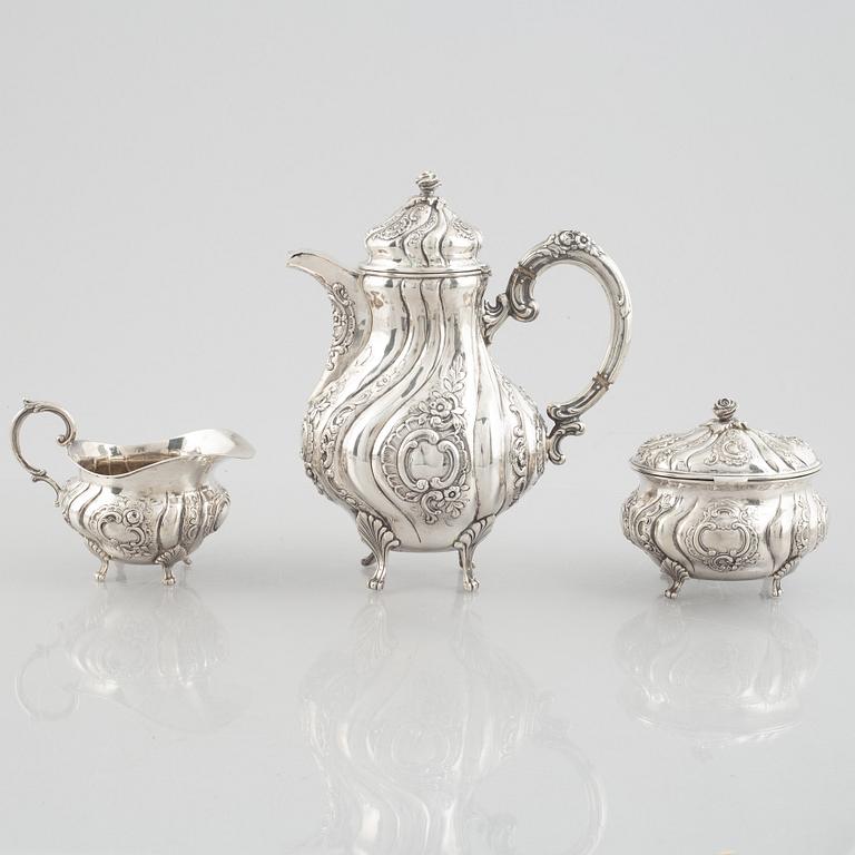 A Rococo-style silver coffee pot, creamer and sugar bowl, 20th Century.
