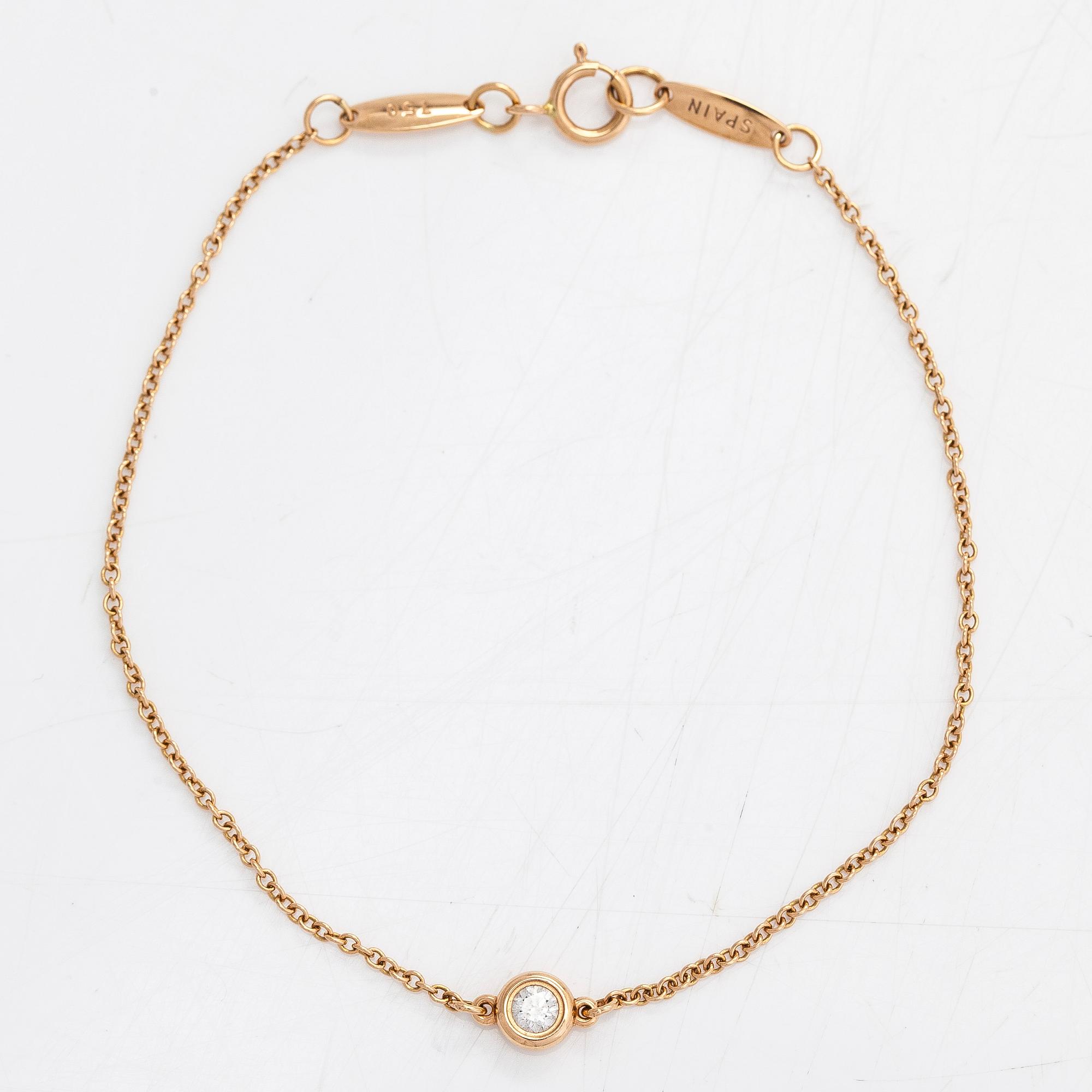 Tiffany & Co, Elsa Peretti, an 18K gold bracelet with a brilliant cut diamond ca 0.07 ct.