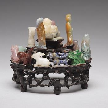 An arrangement of stone sculptures on a wooden stand, China 20th Century.