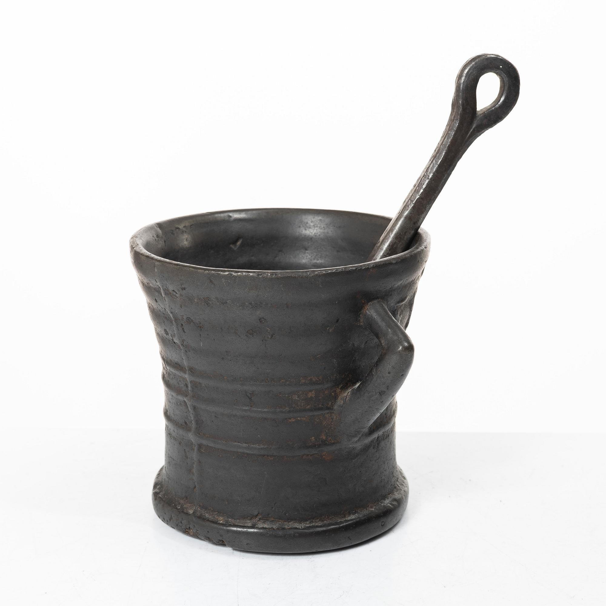 Mortar and pestle, dated 1673.