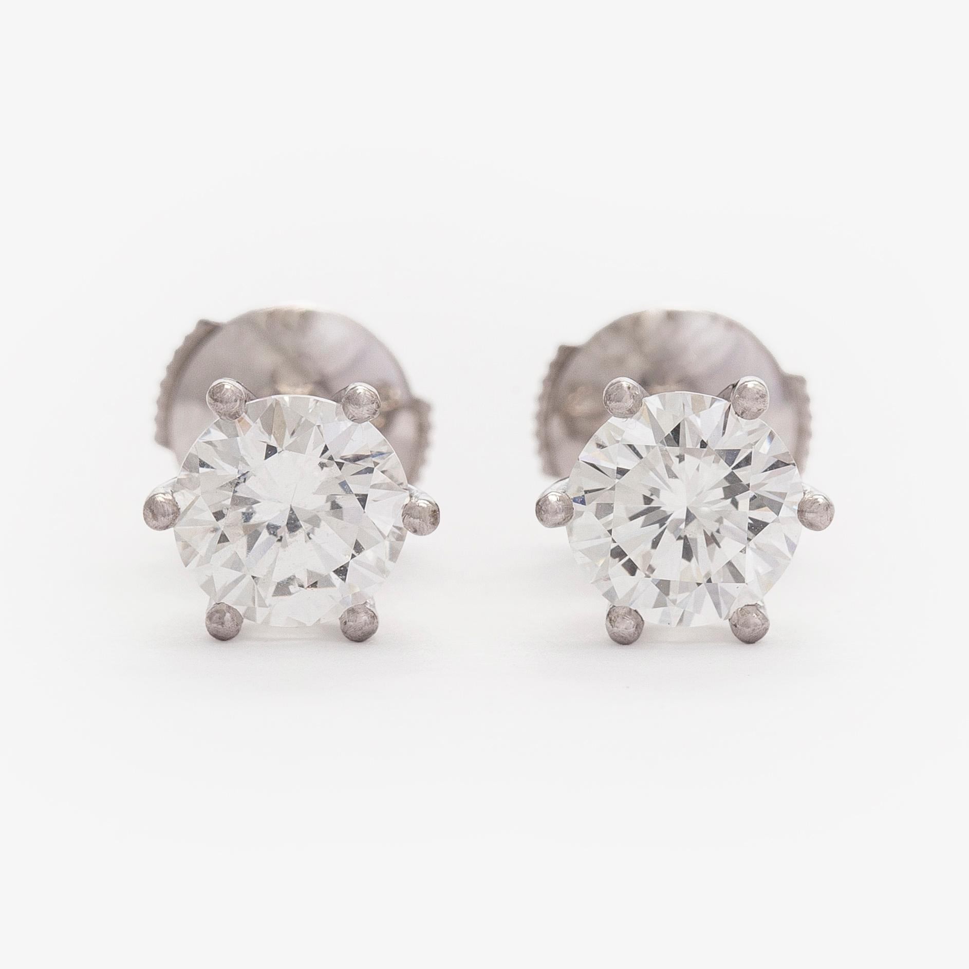 Bucherer, a pair of 18K white gold earrings with brilliant-cut diamond. SJL-certificate.