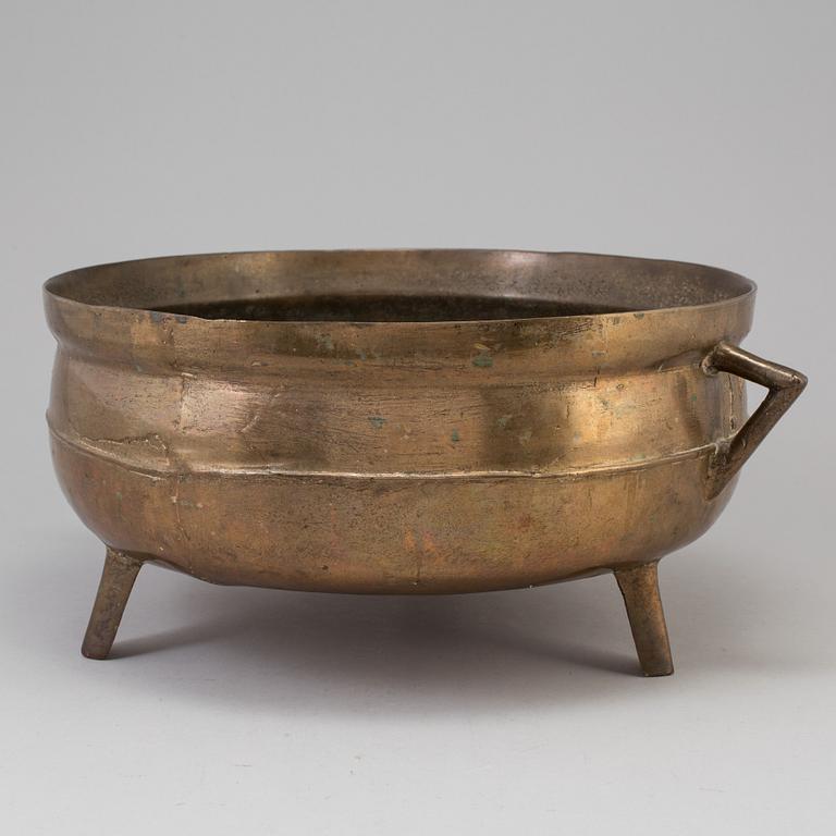 A 19th century brass cauldron.