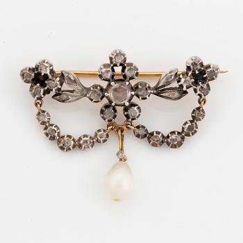 A silver and gold brooch with pearl and rose-cut diamonds.