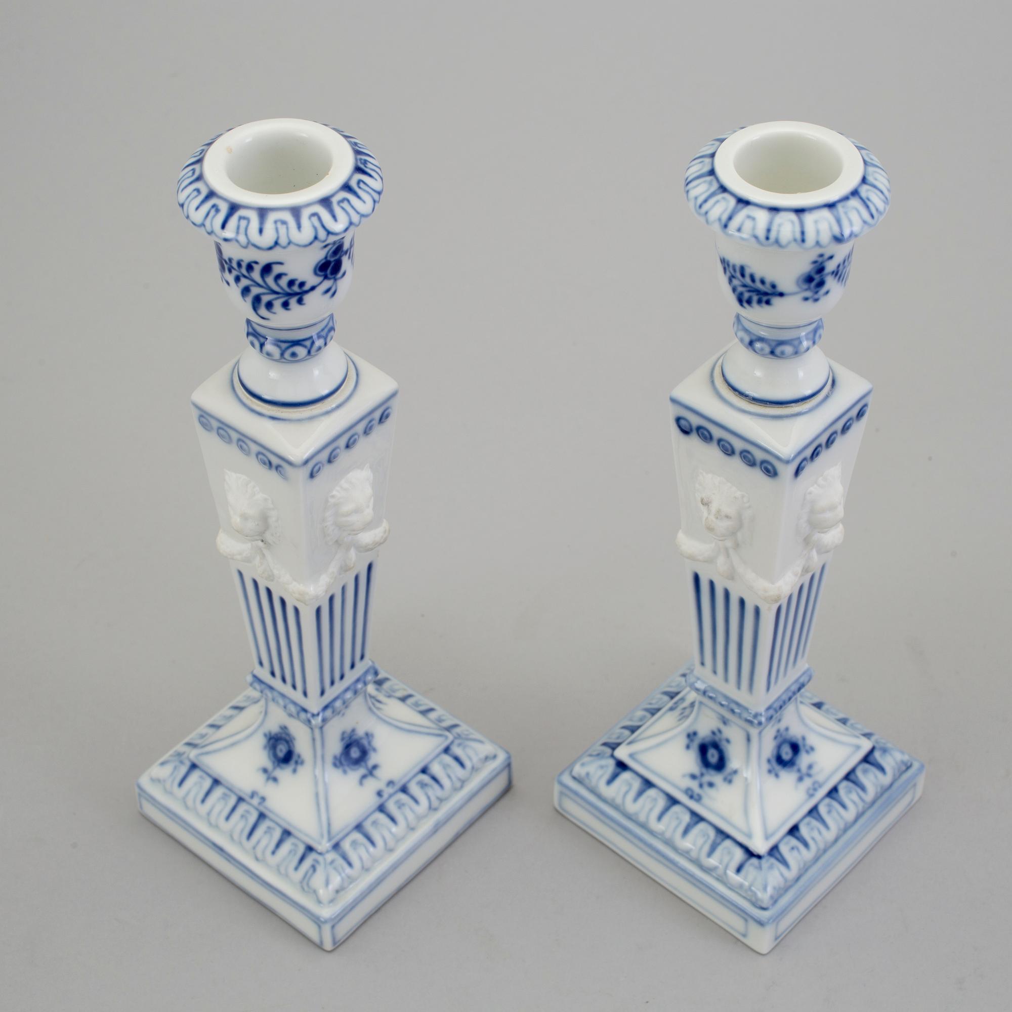 A pair of porcelain candlesticks and a lighter from Royal Copenhagen, Denmark.