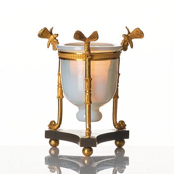 An Empire tripod with an opalin glass bowl, first part of the 19th century.