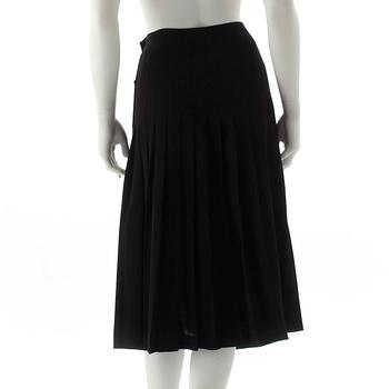 CÉLINE, a black pleated wool skirt.