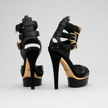 GUCCI, a pair of black leather platform sandalettes.