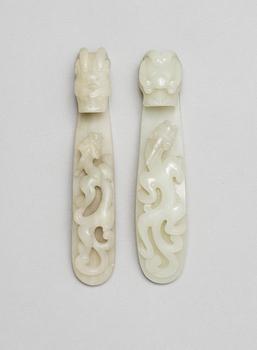 Two pale green garment hooks, Qing dynasty.