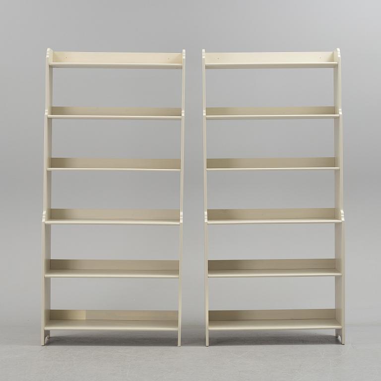 A pair of IKEA "Leksvik" painted bookcases.