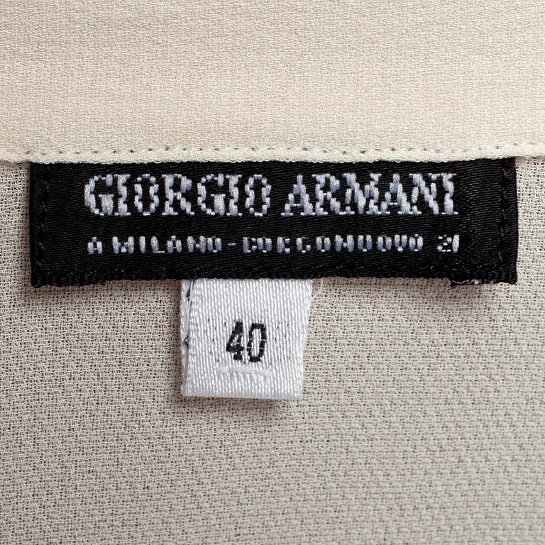 GIORGIO ARMANI, a light beige silk blouse.