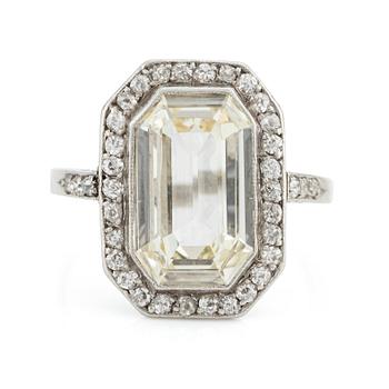569. A platinum ring set with an emerald-cut diamond.