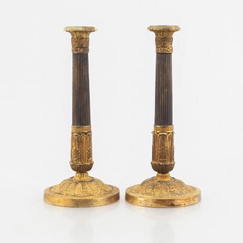 A pair of Empire candle sticks, 19th century.