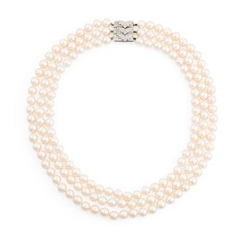 A three strand cultured pearl necklace with a platinum clasp set with eight- and baguette-cut diamonds.