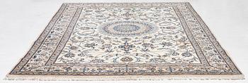 An Oriental carpet, approx. 354 x 243 cm.