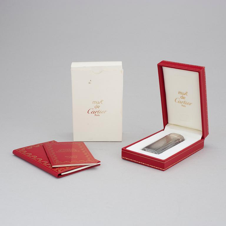 A must de Cartier silver plated cigarette lighter.