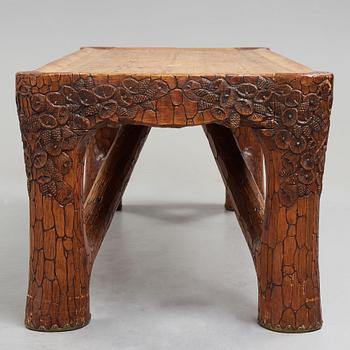 Gustaf Fjaestad, an Art Nouveau carved pine table, Arvika Sweden 1914, a double to the table in the Thiel Collection,