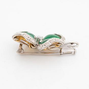 An 18K gold and enamel brooch set with round brilliant-cut diamonds.