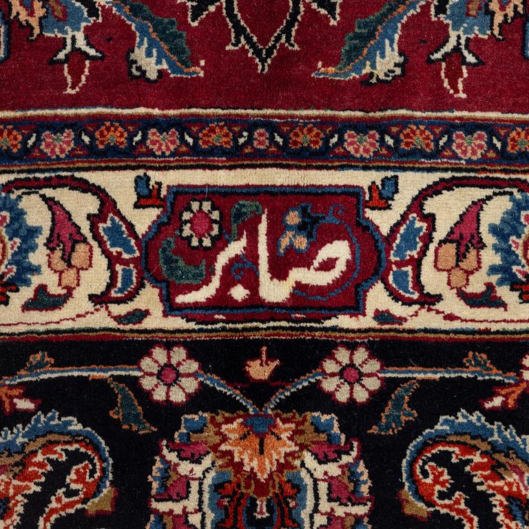 A semi-antique Mashad carpet, signed Saber, c. 401 x 300 cm.
