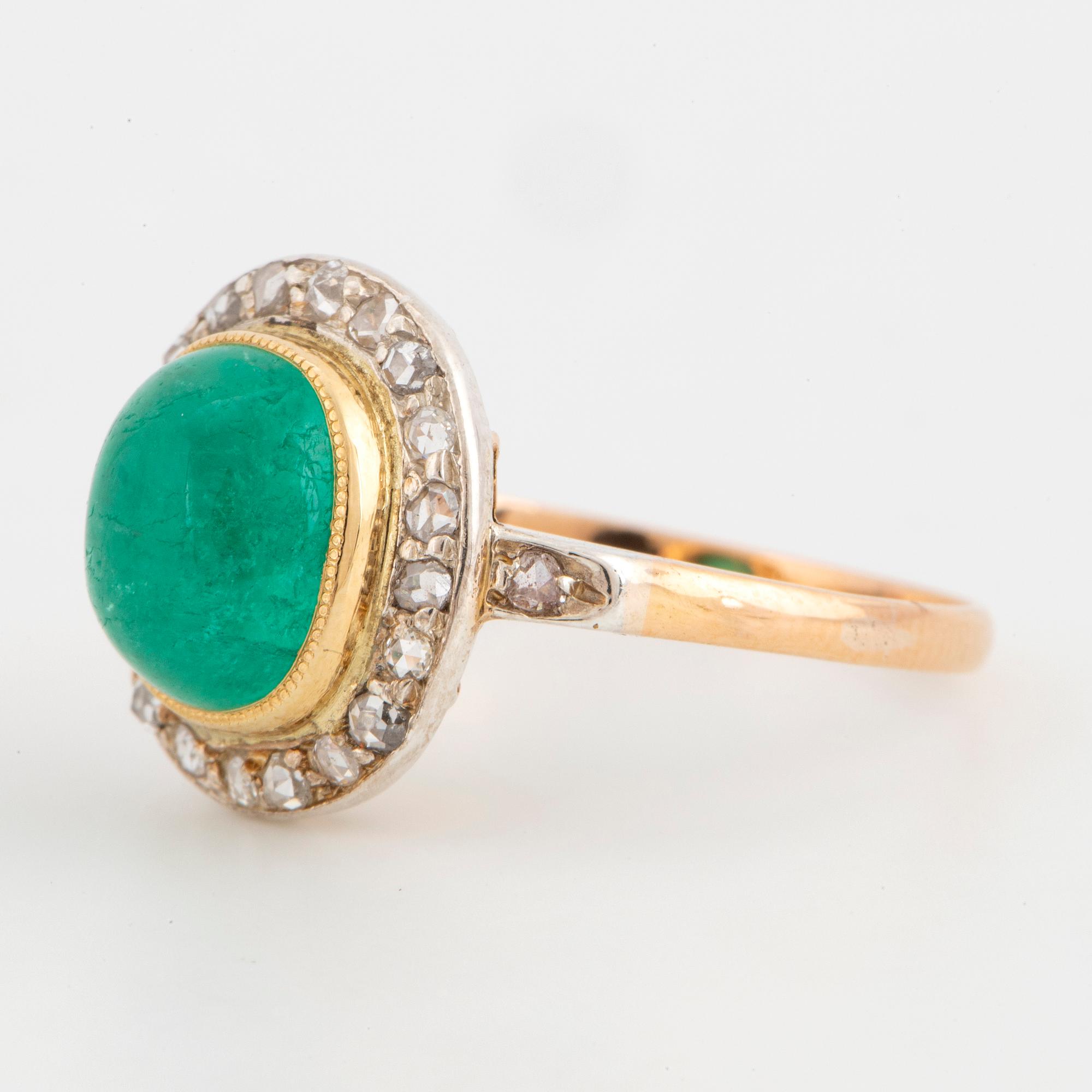 Cabochon-cut emerald and rose-cut diamond cluster ring.