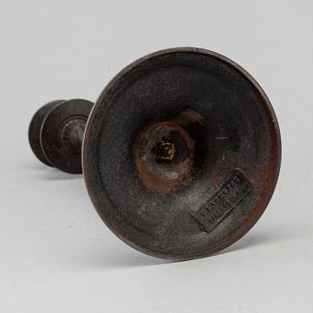 A 19th century iron candlestick marked F.L Vombach Offenbach A/M.