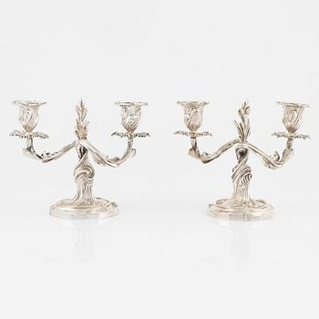 A rococo style pair of silverplated candelabras, end of the 19th Century..