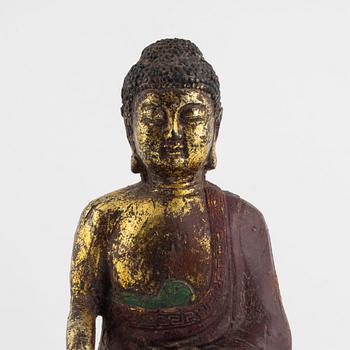 A Chinese cast iron figure of a Buddha, probably late Ming dynasty.