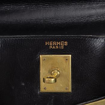 Hermès, a black leather 'Kelly' handbag.