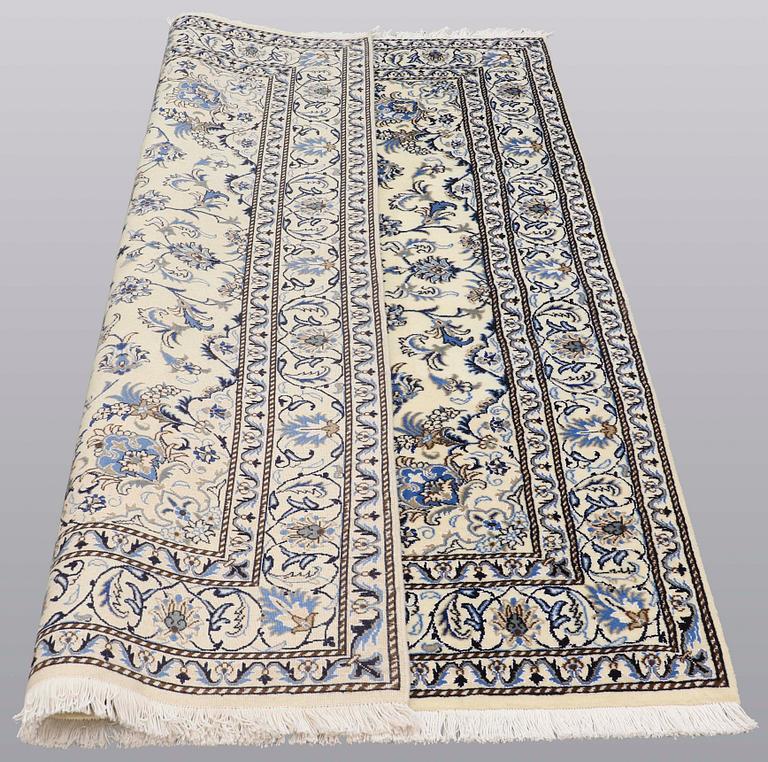 A rug, Nain part silk, ca 235 x 160 cm.