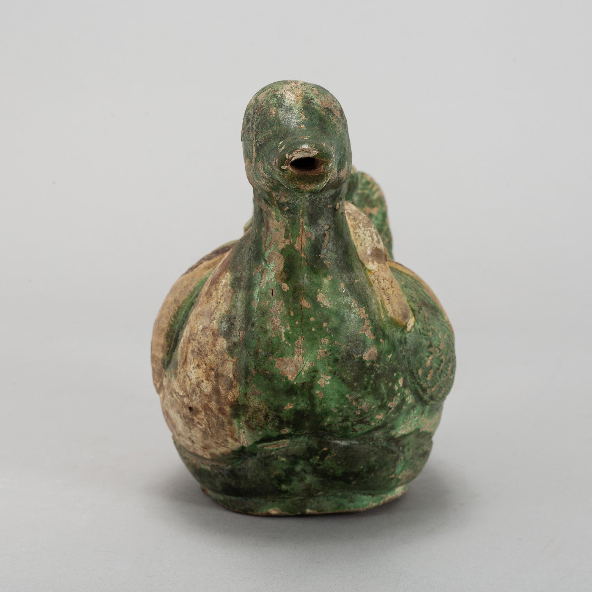 A green and yellow glazed bisquit duckshaped ewer, Ming dynasty (1368-1644).