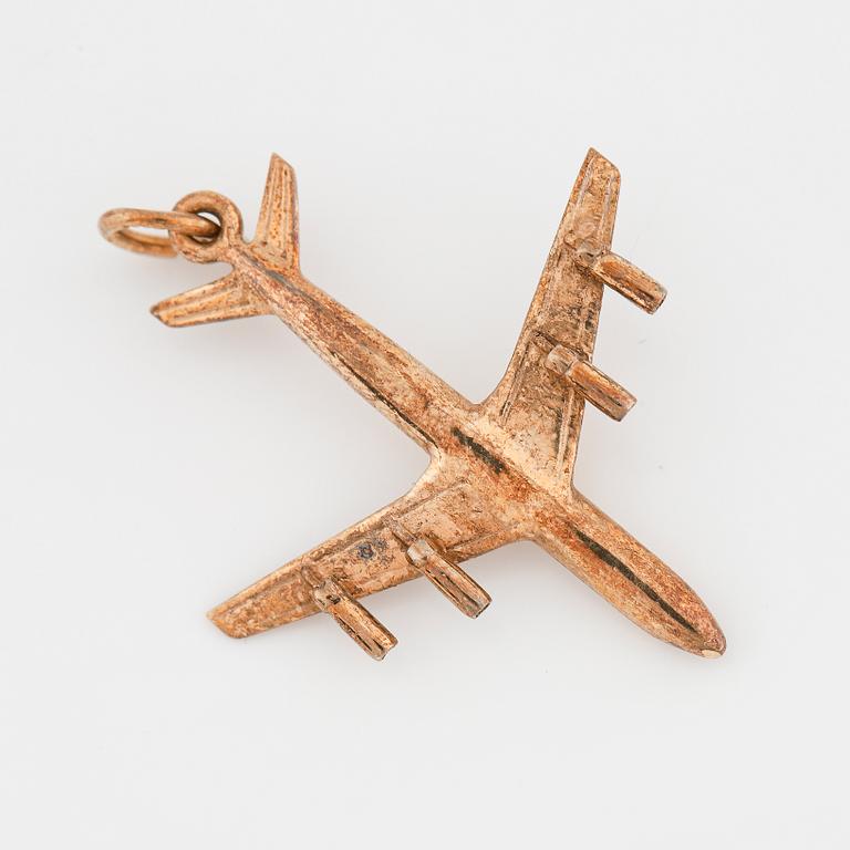 A 14K gold pendant in the form of a plane.