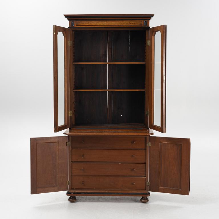 A mahogany veneered book cabinet, around 1900.