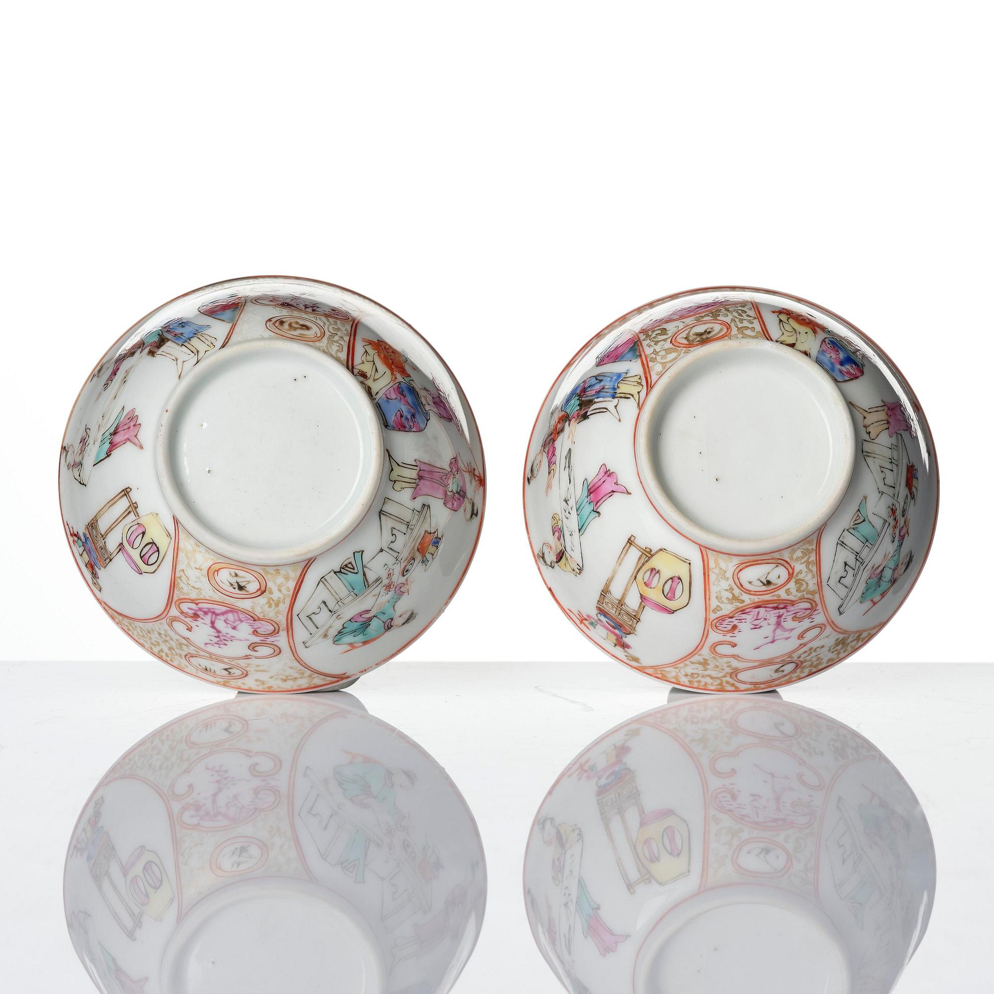 A pair of famille rose 'figural' tea cups with saucers, Qing dynasty, Qianlong (1736-95).