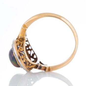 An opal ring set with rose-cut diamonds.