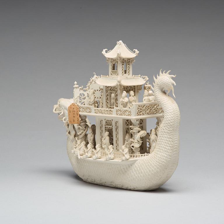 A biscuit porcelain dragon boat of 'Assembly of Immortals', Qing dynasty, Daoguang, signed Chen Guozhi, 19th century.