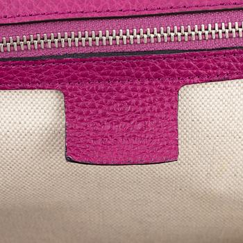 Gucci, a pink leather bamboo handle handbag.