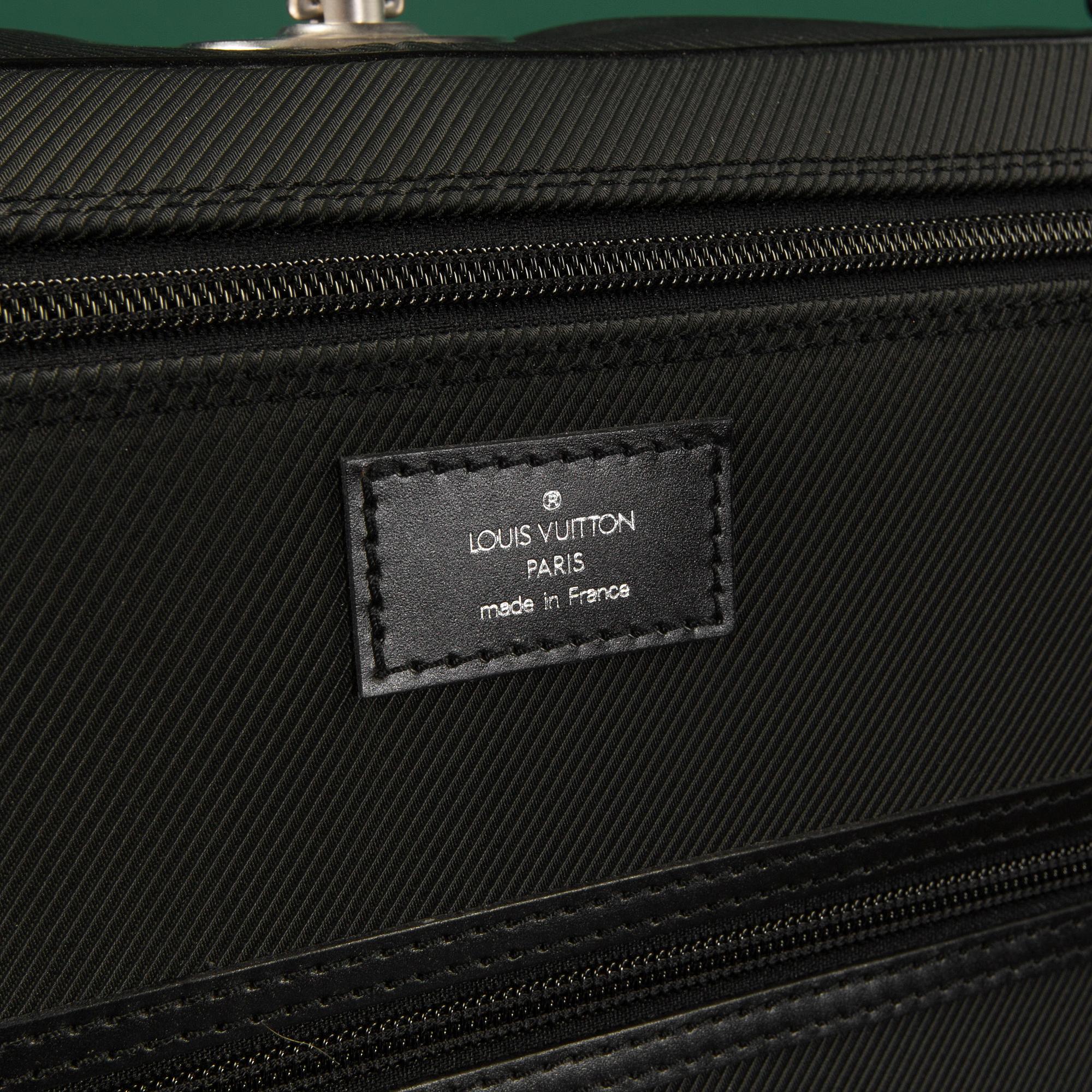 A Garment bag by Louis Vuitton.