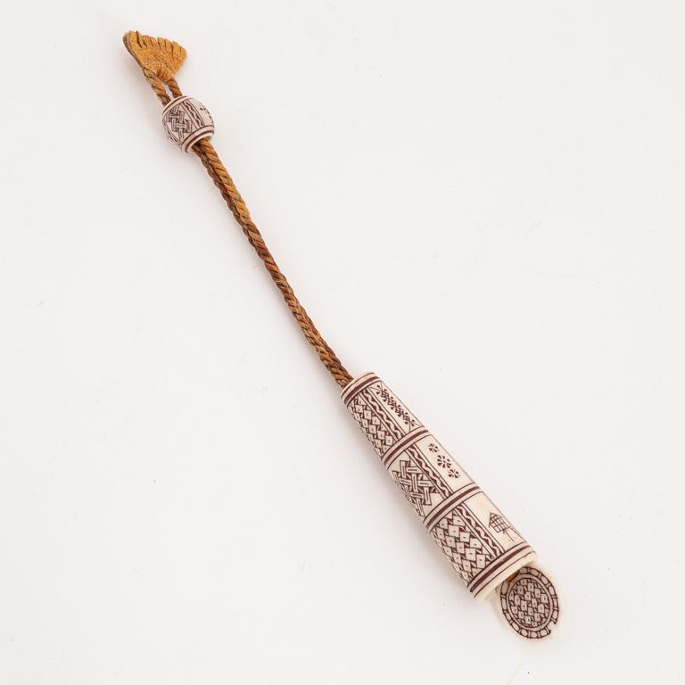 An engraved reindeer needle case.