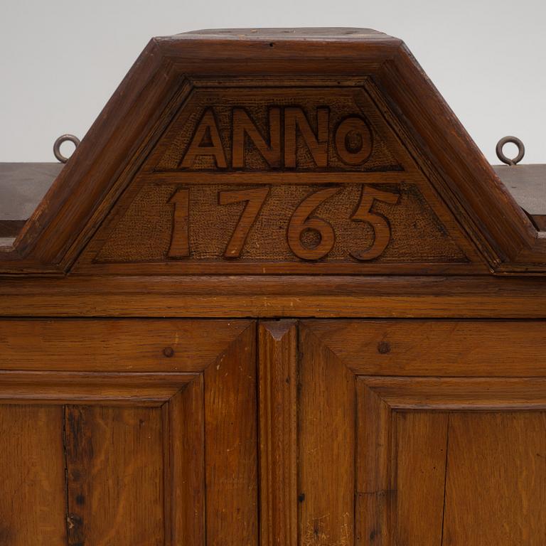 A wall cabinet, dated 1765.