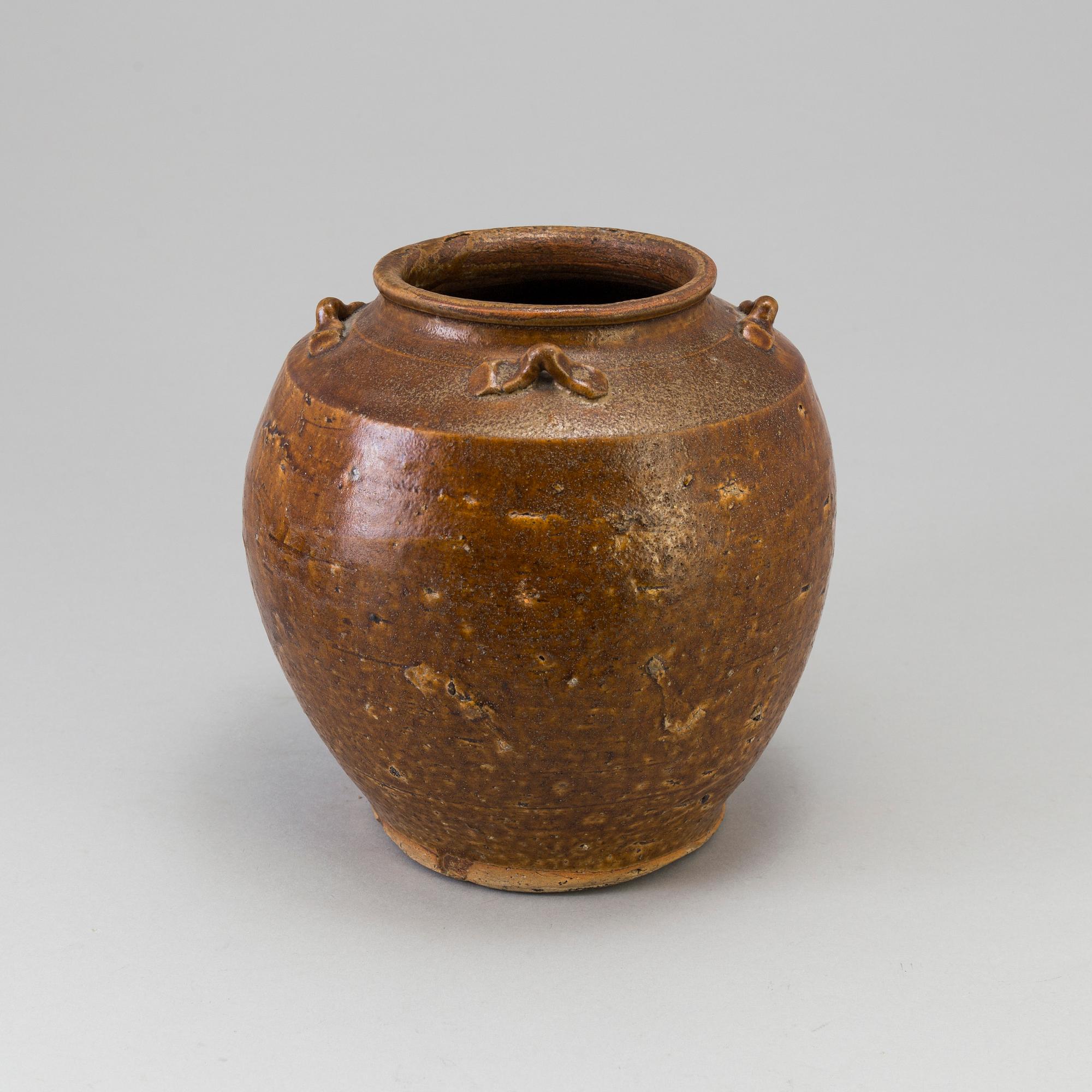 A south east asian pottery urn 18/19th century.