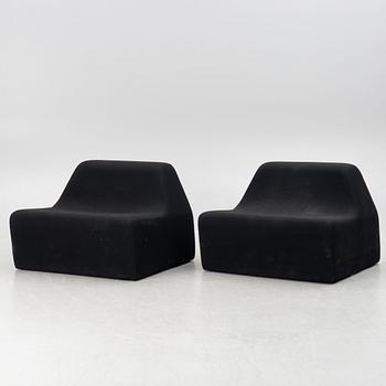 A pair of contemporary lounge chairs.