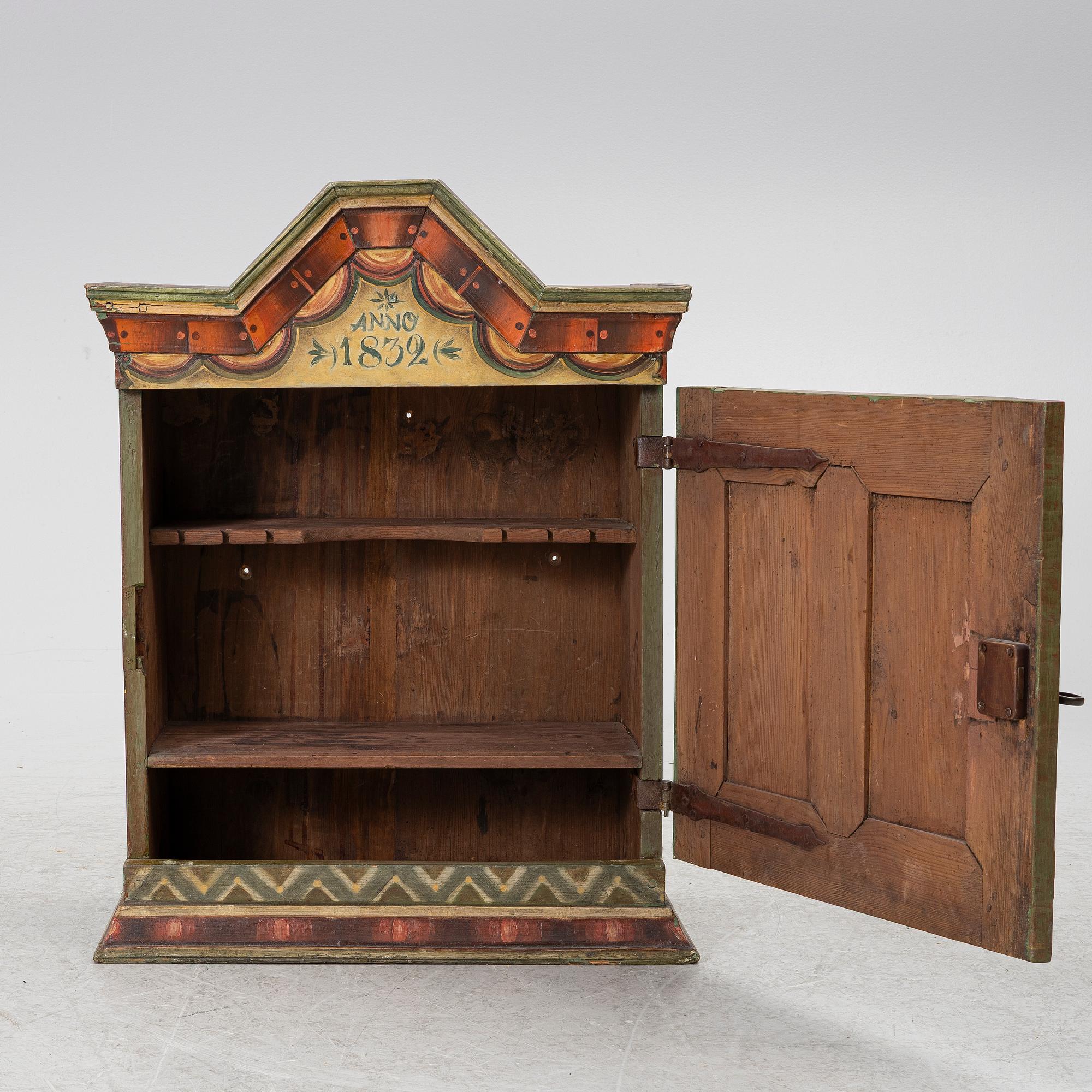 A hanging cabinet, dated 1832.