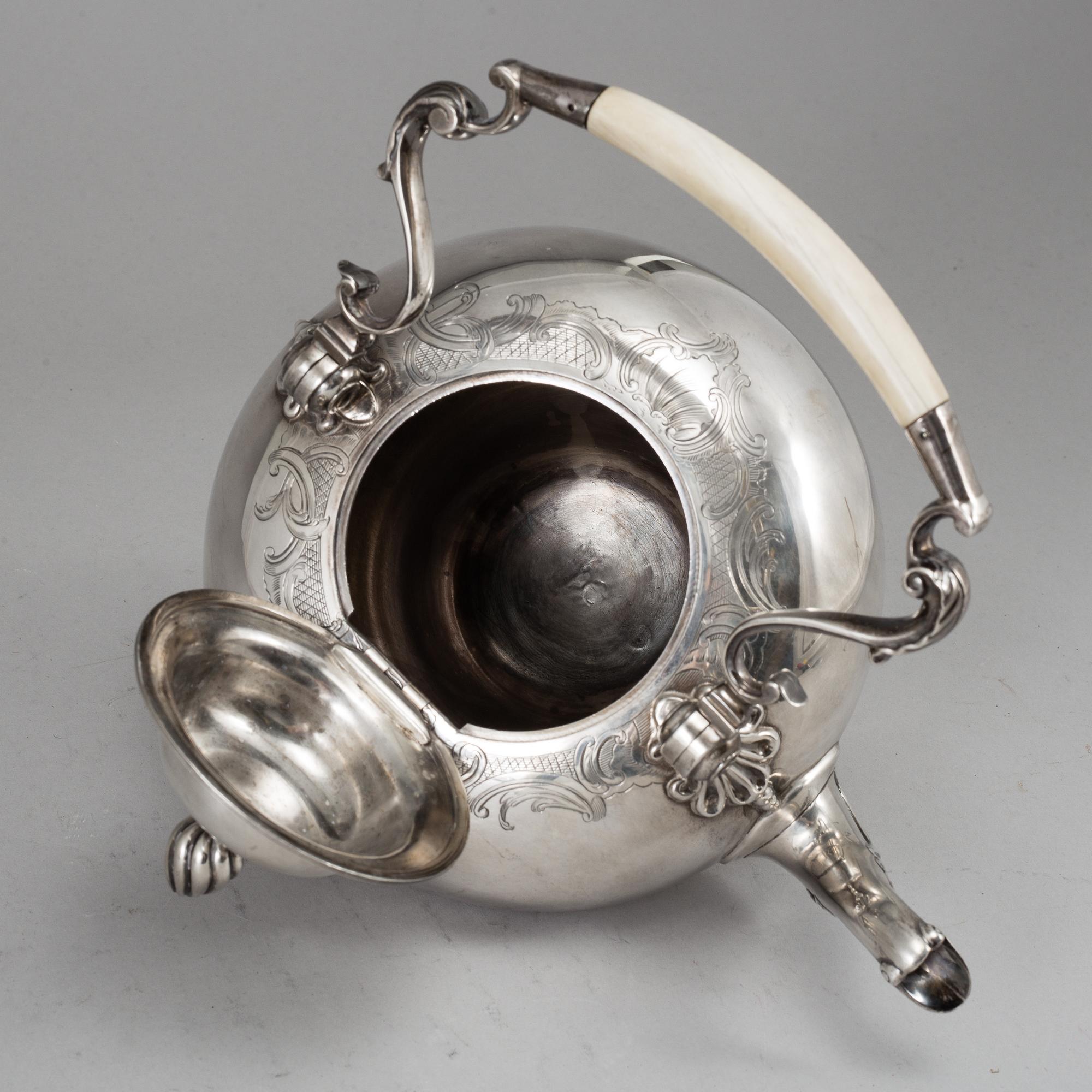 A silver teapot and heater, mark of William Comyns & Sons