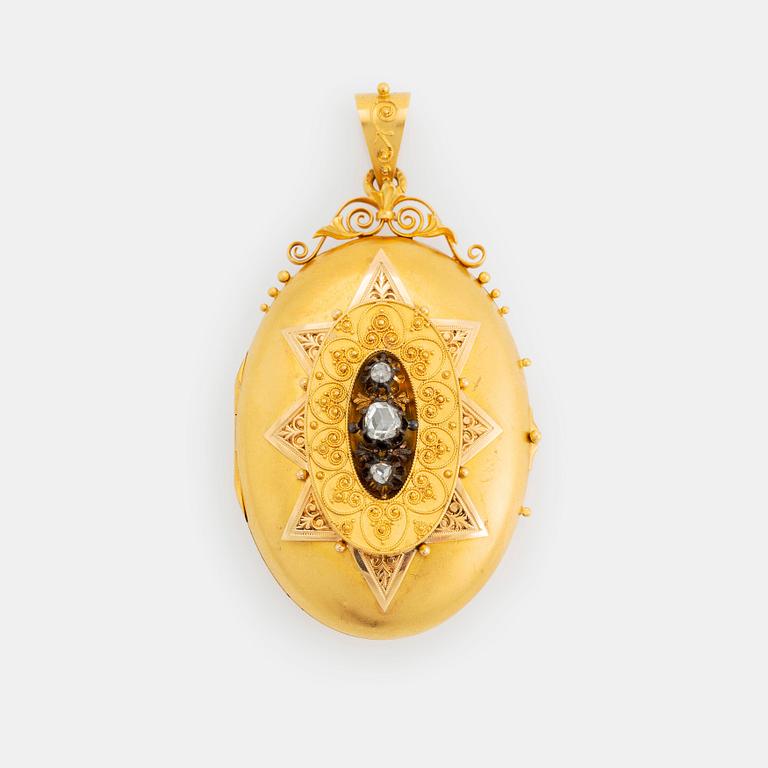 An 18K gold locket set with rose-cut diamonds.